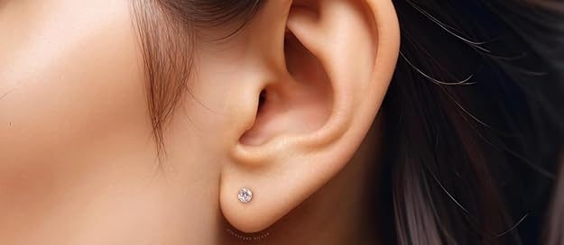 Elegant diamond stud earrings for women displayed on woman's earlobe