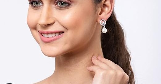 Elegant pearl silver earrings on woman showcasing classic stud design