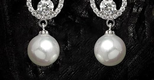 Elegant pearl silver earrings on woman showcasing classic stud design